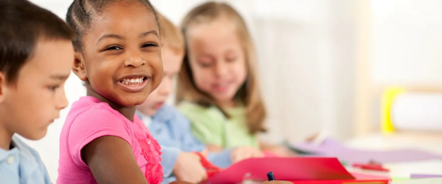 preschool children sitting at table coloring