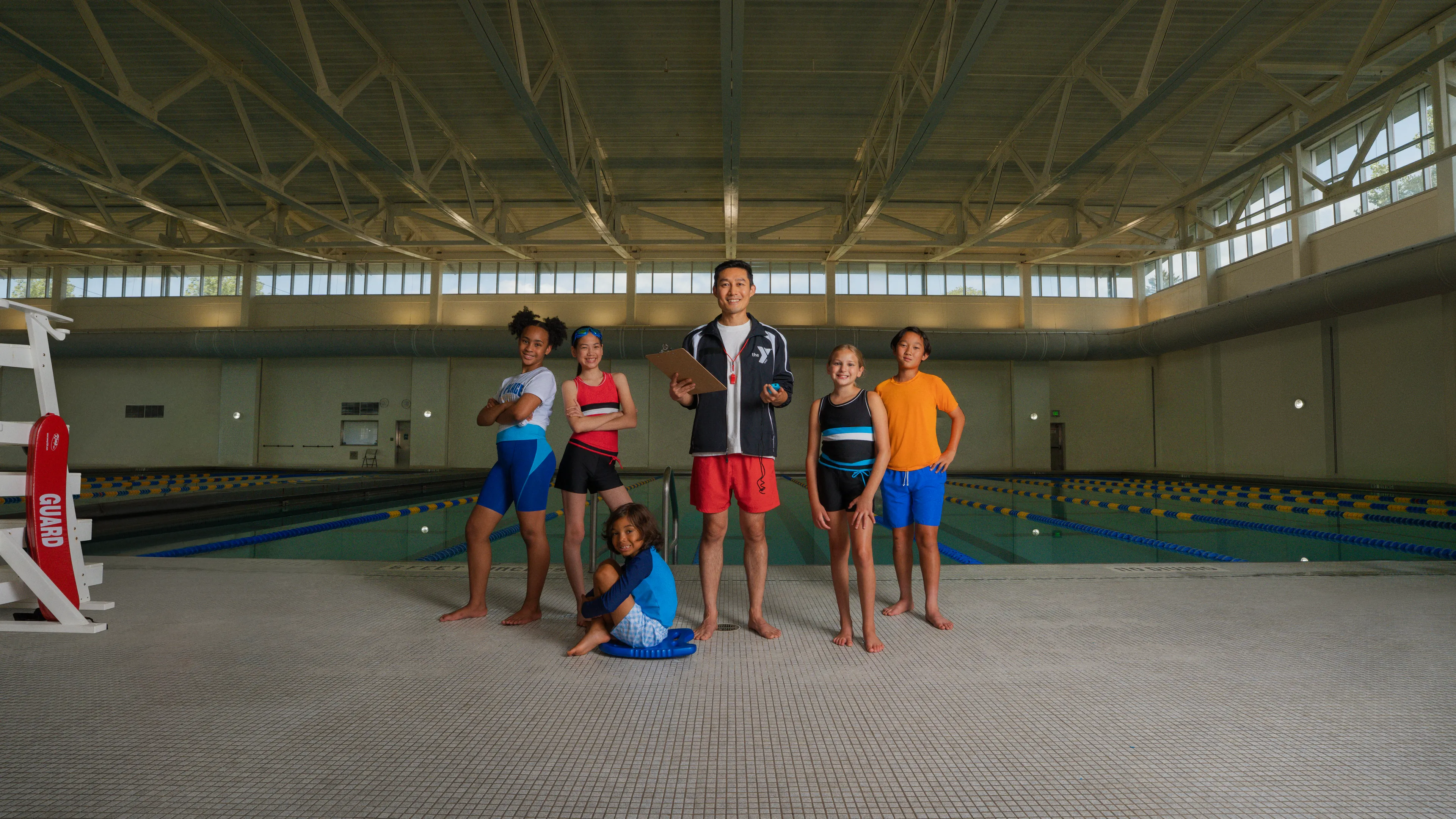 Instructor and kids around the pool