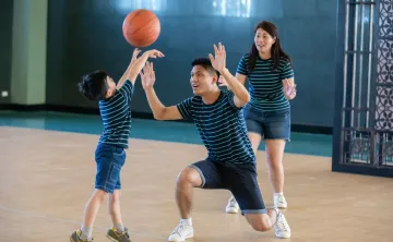 Family playing basketball