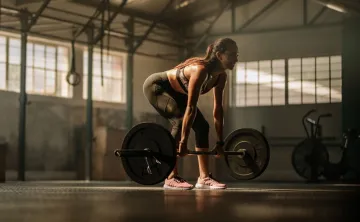 Picture of a woman lifting heavy weight